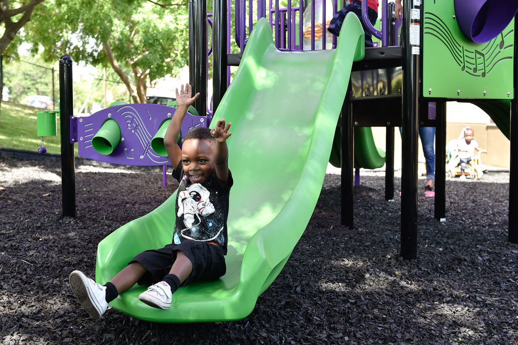 Children have fun on a newly built play area at Fred Moore Day Nursery School. Floyd Smith Concrete is the company that built the play area at Fred Moore Day Nursery School. The company is building it through a grant.